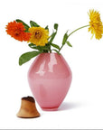 Pink vase with flowers on a white background