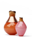 Two decorative vases, one orange and one pink, with wooden tops on a white background.