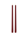 Two tall, thin led taper candles in a deep burgundy red color, standing upright side-by-side against a solid white background.