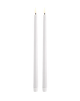 Two slim white led taper candles standing upright side by side on a plain white background.