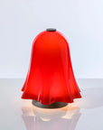 Red bell-shaped lamp on a white background from Venini at Spacio store in Mumbai