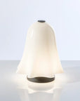 White lamp with black accents on a light gray background from Venini at Spacio store in Mumbai