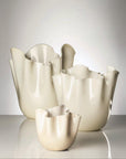Set of three Cream-colored venini murano vase on a white background at Spacio retail store in Mumbai