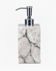 White quartz with silver foil soap loation dispenser with silver pump on a white background