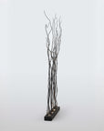 Decorative floor lamp with black branches on a white background