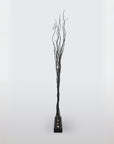 Decorative floor lamp with black branches on a white background