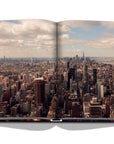 Assouline New York Chic coffee table book displaying drone shot photo whole New York city on white back ground available at Spacio India for luxury home decor accessories collection of Travel Coffee Table Books.
