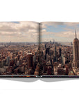 Assouline New York Chic coffee table book displaying drone shot photo whole New York city on white back ground available at Spacio India for luxury home decor accessories collection of Travel Coffee Table Books.