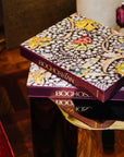 Assouline Boghossian: Expertise Craftsmanship Innovation coffee table book on gold finish coffee table in a cozy living room interior at Spacio India for luxury home decor collection of Jewellery Coffee Table Books.
