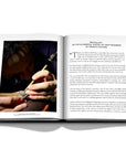 Assouline Buccellati: A Century of Timeless Beauty coffee table book displaying Jewellery crafting artist working on jewel piece on a white background at Spacio India for luxury home decor collection of Jewellery Coffee Table Books.