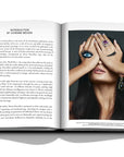 Assouline Buccellati: A Century of Timeless Beauty coffee table book displaying Emerald and diamond pearl drop earrings and ring on a white background at Spacio India for luxury home decor collection of Jewellery Coffee Table Books.