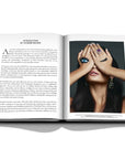 Assouline Buccellati: A Century of Timeless Beauty coffee table book displaying Emerald and diamond pearl drop earrings and ring on a white background at Spacio India for luxury home decor collection of Jewellery Coffee Table Books.