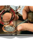 Assouline Bvlgari: Beyond Time coffee table book displaying The new Bulgari Monete High Jewellery Pendant Secret Watch features an ancient silver Greek coin on white back ground at Spacio India for luxury home decor collection of Jewellery Coffee Table Books.