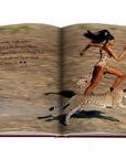 Assouline Cartier: Panthere coffee table book displaying Model Naomi Campbell running with a Panther on white back ground at Spacio India for luxury home decor collection of Jewellery Coffee Table Books.