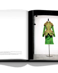 Assouline Dior by John Galliano coffee table book displaying green dress for a fashion week wore by Philippe Wojazer on a white back ground available at Spacio India for luxury home decor collection of Fashion Coffee Table Books.