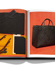 Assouline Louis Vuitton Manufactures coffee table book displaying photo of Black Bag with its parts on white background at Spacio India for luxury home decor collection of Fashion Coffee Table Books.