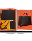 Assouline Louis Vuitton Manufactures coffee table book displaying photo of Black Bag with its parts on white background at Spacio India for luxury home decor collection of Fashion Coffee Table Books.