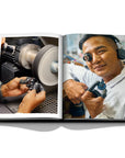 Assouline Louis Vuitton Manufactures coffee table book displaying photo of craftsman working on clock making on white background at Spacio India for luxury home decor collection of Fashion Coffee Table Books.
