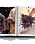 Assouline Louis Vuitton Manufactures coffee table book displaying photo of dry Lavendor flowers & steel smoker on white background at Spacio India for luxury home decor collection of Fashion Coffee Table Books.