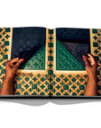 Assouline Louis Vuitton Manufactures coffee table book displaying photo of Louis Vuitton Green & Yellow Pattern on white background at Spacio India for luxury home decor collection of Fashion Coffee Table Books.