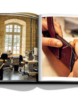 Assouline Louis Vuitton Manufactures coffee table book displaying photo of leather suing work & workplace on white background at Spacio India for luxury home decor collection of Fashion Coffee Table Books.