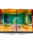 Assouline Louis Vuitton: Virgil Abloh Classic Cartoon Cover coffee table book displaying photo of Louis Vuitton Pop Up Residency Soho on a white back ground available at Spacio India for luxury home decor accessories collection of Fashion Coffee Table Books.