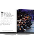 Assouline Louis Vuitton: Virgil Abloh Classic Cartoon Cover coffee table book displaying photo of Virgil Abloh at Fashion Week show with audience on a white back ground available at Spacio India for luxury home decor accessories collection of Fashion Coffee Table Books.