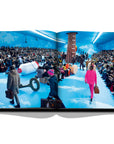 Assouline Louis Vuitton: Virgil Abloh Classic Cartoon Cover coffee table book displaying photo of The men’s collection by US designer Virgil Abloh for Louis Vuitton fashion house during the Paris Fashion Week, January 2020 on a white back ground available at Spacio India for luxury home decor accessories collection of Fashion Coffee Table Books.