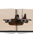 Assouline Louis Vuitton: Virgil Abloh Classic Cartoon Cover coffee table book displaying photo of Louis Vuitton Airplane Bag woth Rs. 28 Lacs on a white back ground available at Spacio India for luxury home decor accessories collection of Fashion Coffee Table Books.
