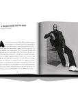 Assouline Louis Vuitton: Virgil Abloh Classic Cartoon Cover coffee table book displaying Image of Virgil Abloh & information on a white back ground available at Spacio India for luxury home decor accessories collection of Fashion Coffee Table Books.
