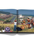 Assouline Formula 1: The Impossible Collection coffee table book people watching race in 1986 from a distance on a white back ground available at Spacio India for luxury home decor collection of Ultimate & Sports Coffee Table Books.