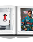 Assouline Formula 1: The Impossible Collection coffee table book F1 Michael Schumacher 2001in his printed Race suit on a white back ground available at Spacio India for luxury home decor collection of Ultimate & Sports Coffee Table Books.