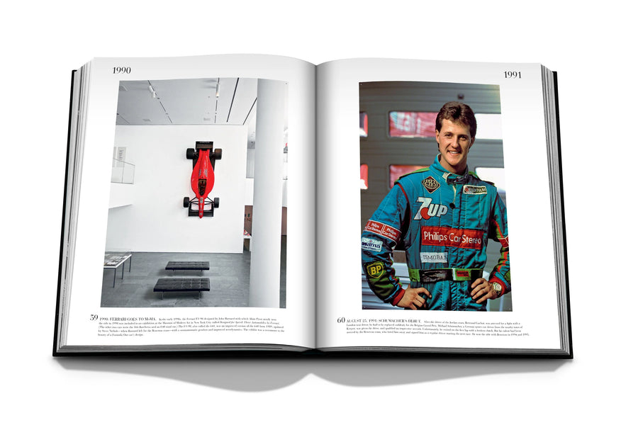 Assouline Formula 1: The Impossible Collection coffee table book F1 Michael Schumacher 2001in his printed Race suit on a white back ground available at Spacio India for luxury home decor collection of Ultimate & Sports Coffee Table Books.