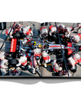 Assouline Formula 1: The Impossible Collection coffee table book McLaren MP4-22, Car model with other people on a white back ground available at Spacio India for luxury home decor collection of Ultimate & Sports Coffee Table Books.