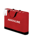 Red Carry Bag of Assouline Formula 1: The Impossible Collection coffee table book on a white back ground available at Spacio India for luxury home decor collection of Ultimate & Sports Coffee Table Books.