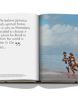 Assouline James Bond: Destinations coffee table book displaying photo of Ursula Andress with James Bond for Beach shooting at on a white background available at Spacio India for luxury home decor accessories collection of Travel Coffee Table Books.