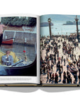 Assouline James Bond: Destinations coffee table book displaying photo of St. Mark's Square & Italy in the late 80’s at on a white background available at Spacio India for luxury home decor accessories collection of Travel Coffee Table Books.