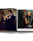Assouline James Bond: Destinations coffee table book displaying photo of Masquerade party of actors at on a white background available at Spacio India for luxury home decor accessories collection of Travel Coffee Table Books.