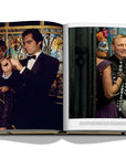 Assouline James Bond: Destinations coffee table book displaying photo of Masquerade party of actors at on a white background available at Spacio India for luxury home decor accessories collection of Travel Coffee Table Books.