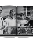 Assouline Louis Vuitton: Trophy Trunks coffee table book displaying image of Dwight Filley Davis spent $750 for the crafting of a beautiful silver bawl that was completed on February 9, 1900 on a white back ground available at Spacio India for luxury home decor accessories collection of Fashion Coffee Table Books.