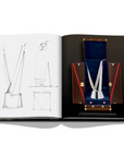 Assouline Louis Vuitton: Trophy Trunks coffee table book displaying image of Nba Trophy Louis Vuitton with sketches on a white back ground available at Spacio India for luxury home decor accessories collection of Fashion Coffee Table Books.