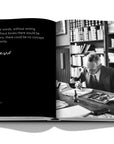 Assouline Montblanc coffee table book displaying picture of The English author, poet and Nobel laureate in literature of the year 1946, Hermann Hesse works on an illustration in the study of his residence in Montagnola & his Signature available at Spacio India for luxury home decor accessories collection of Fashion Coffee Table Books.