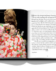 Assouline Moschino coffee table book displaying photos of Supermodel Gigi Hadid with a quote on a white back ground available at Spacio India for luxury home decor accessories collection of Fashion Coffee Table Books.