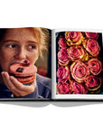 Assouline Paris Chic coffee table book displaying photos of Roses & a girl eating donut in Paris on white back ground available at Spacio India for luxury home decor accessories collection of Travel Coffee Table Books.