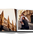 Assouline Paris Chic coffee table book displaying photos of Paris Apartments Windows & a happy couple on white back ground available at Spacio India for luxury home decor accessories collection of Travel Coffee Table Books.