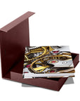 Opened Box of Assouline Coffee Table Book The Impossible Collection of Watches on a white back ground available at Spacio India for luxury home decor accessories collection of Ultimate Coffee Table Books.