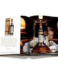 Assouline Coffee Table Book The Impossible Collection of Whiskey page displaying a photo of The Macallan 1926, a rare & old Whiskey bottle on a white back ground available at Spacio India for luxury home decor accessories collection of Ultimate Coffee Table Books.