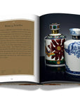 Assouline Coffee Table Book The Impossible Collection of Whiskey page displaying a photo of 35 years old whiskey ceramic bottles on a white back ground available at Spacio India for luxury home decor accessories collection of Ultimate Coffee Table Books.