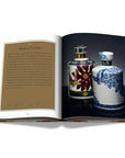 Assouline Coffee Table Book The Impossible Collection of Whiskey page displaying a photo of 35 years old whiskey ceramic bottles on a white back ground available at Spacio India for luxury home decor accessories collection of Ultimate Coffee Table Books.
