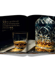 Assouline Coffee Table Book The Impossible Collection of Whiskey page displaying a photo of the glass & decanter on a white back ground available at Spacio India for luxury home decor accessories collection of Ultimate Coffee Table Books.
